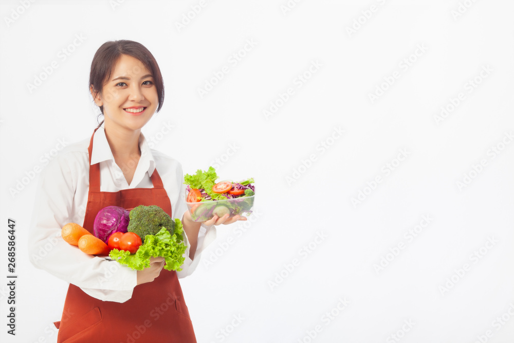 Asian young woman stands to hold vegetables with fresh fruit, Healthy diet. Antioxidant in meal, Risks in food safety, Clean eating food concept with copy space.