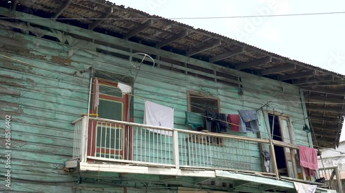 Laundry hangs from upper level of very dilapidated run down old building in Panama City, Panama