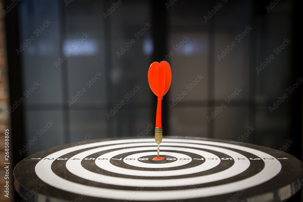 Red dart target arrow hitting on bullseye with,Target marketing and business success concept - Image Red dart target arrow hitting on bullseye with,Target marketing and business success concept - Image