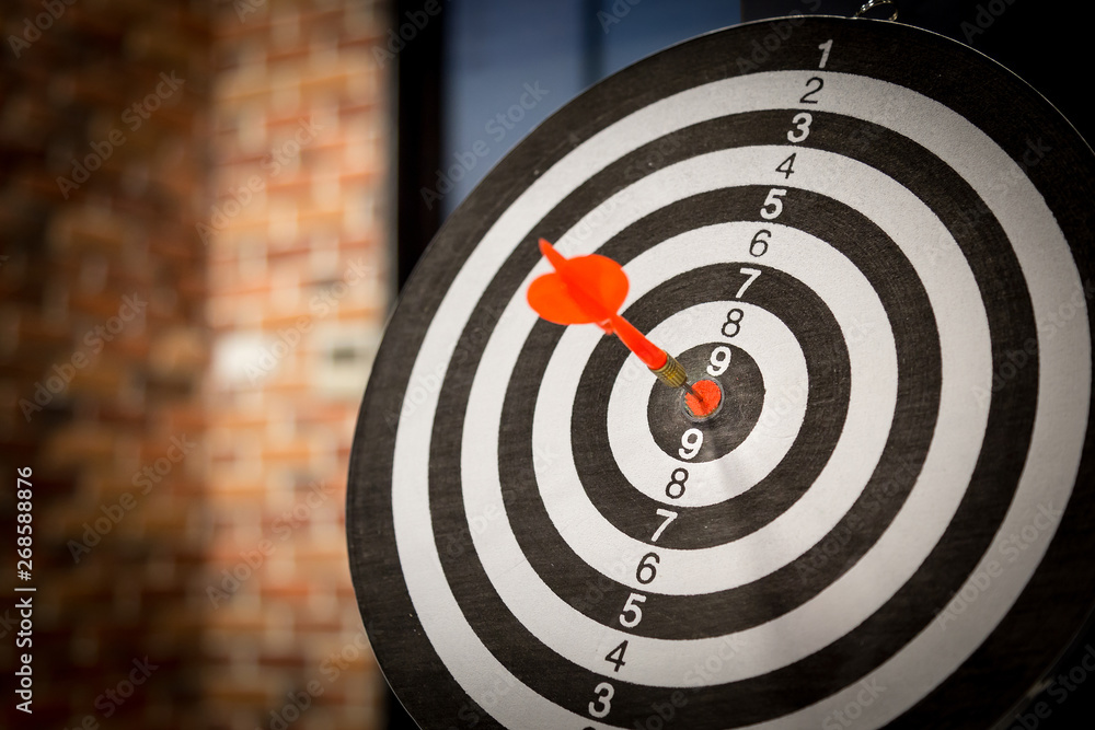 Red dart target arrow hitting on bullseye with,Target marketing and business success concept - Image Red dart target arrow hitting on bullseye with,Target marketing and business success concept - Image