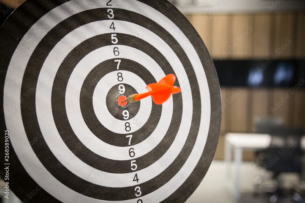 Red dart arrow hitting in the target center of dartboard on bullseye with sun light vintage style, Target marketing and business success concept - Image. Red dart arrow hitting in the target center of dartboard on bullseye with sun light vintage style, Target marketing and business success concept - Image.