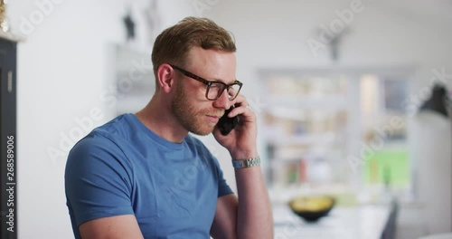 4K Casual business entrepreneur working on laptop at home & talking on phone