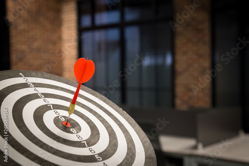 Red dart arrow hitting in the target center of dartboard on bullseye with sun light vintage style, Target marketing and business success concept - Image.