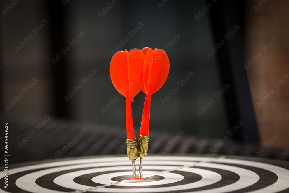 Red dart target arrow hitting on bullseye with,Target marketing and business success concept - Image Red dart target arrow hitting on bullseye with,Target marketing and business success concept - Image