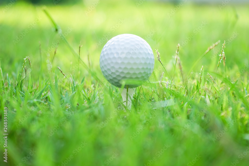 Golf ball on tee in beautiful golf course at sunset background. Golf ball on tee in beautiful golf course at sunset background.
