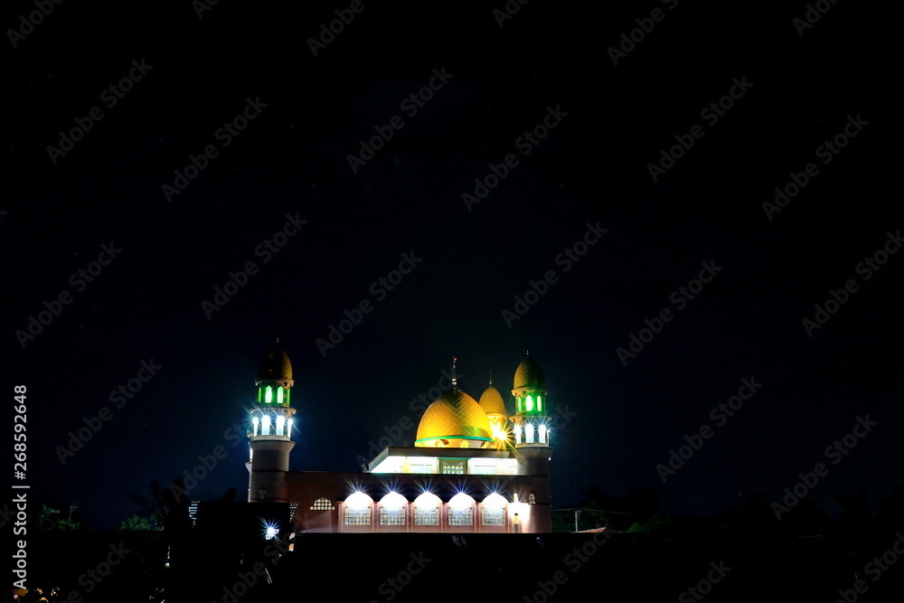 mosque with a dark background, photographed at night with natural light