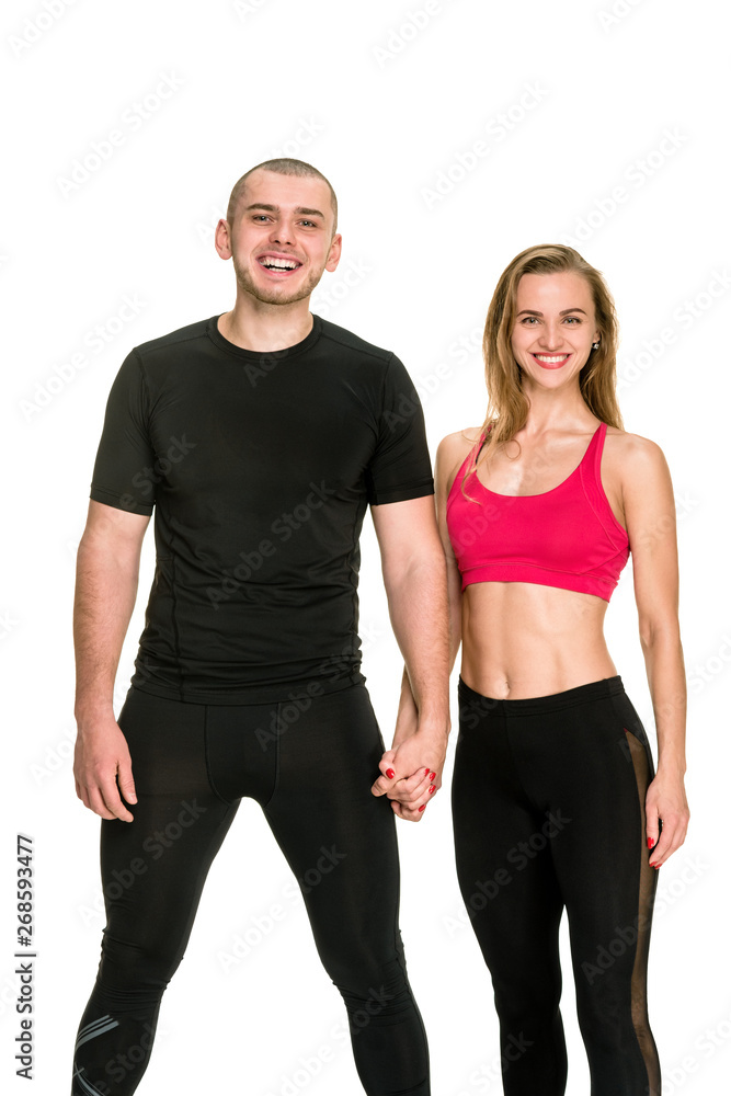 Portrait of confident athletic man and woman in sportswear with crossed hands Portrait of confident athletic man and woman in sportswear with crossed hands
