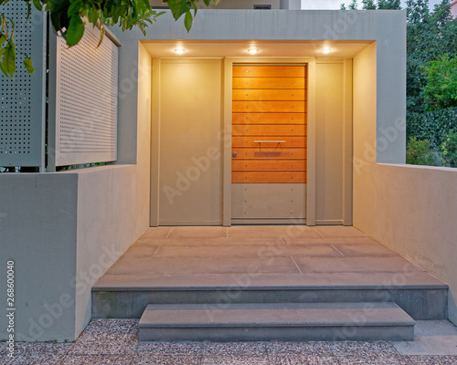 contemporary design apartment building entrance door, illuminated photo