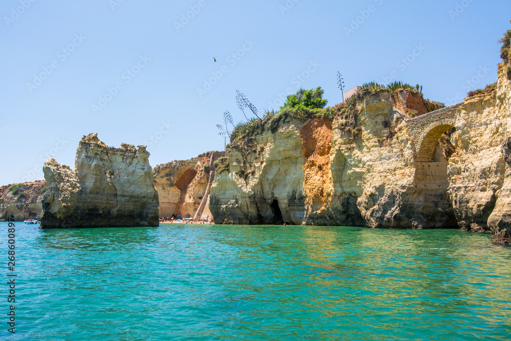 Naklejka premium Famous Rocks in Sea, Ocean, Lagos in Portugal. Popular summer travel destination and famous beach at Algarve coastline