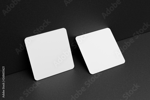 3D render Mock-up of the two square business cards are on a black paper