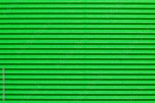 Abstract textured background created with striped details of green corrugated cardboard