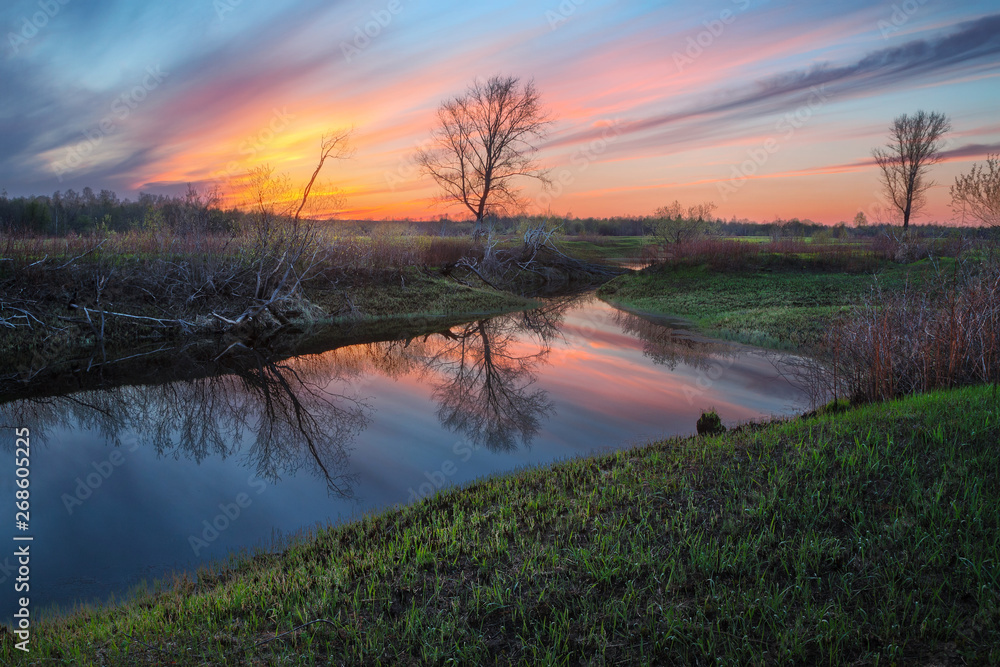 reflection of a beautiful sunset in a spring pond