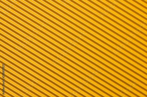 Abstract textured background created with striped details of yellow corrugated cardboard