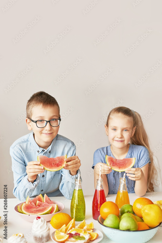 Children eat fruit pineapple, watermelon, apples and drink drinks with chia. Healthy food in the children's menu Children eat fruit pineapple, watermelon, apples and drink drinks with chia. Healthy food in the children's menu