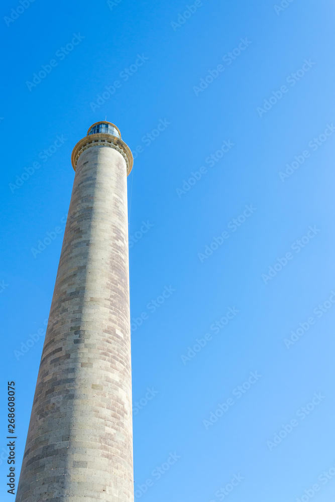 Lighthouse against the blue sky. Bottom view. Travels. Maritime architecture.