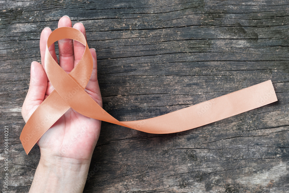 Φωτογραφία Uterine and Gynecologic Cancer Awareness peach color ribbon on woman’s hand and