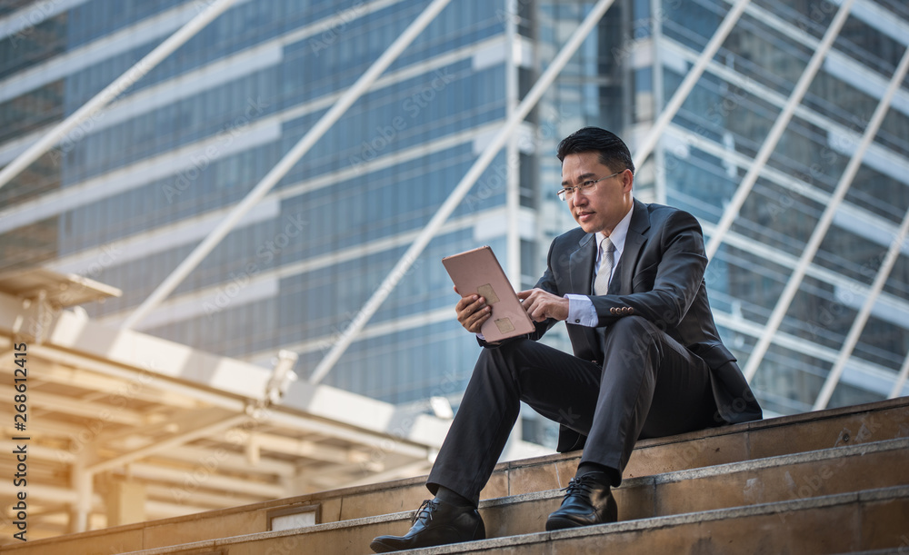 Businessman with laptop on the stairs. Businessman with laptop on the stairs.