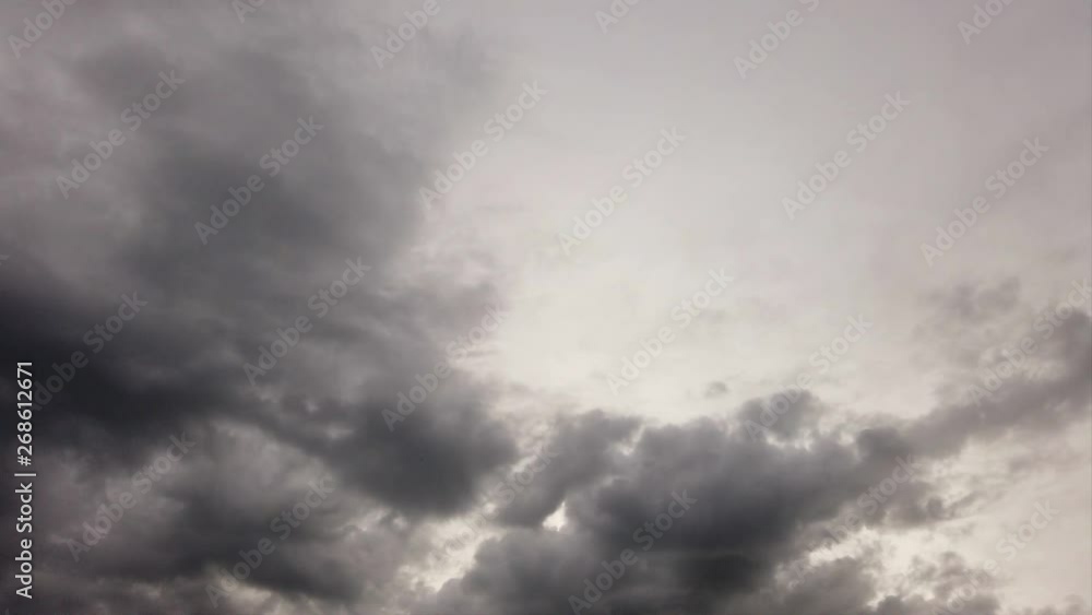 Spooky sky with dense dark nimbostratus clouds with multi-level layer and dramatic lights in timelapse
