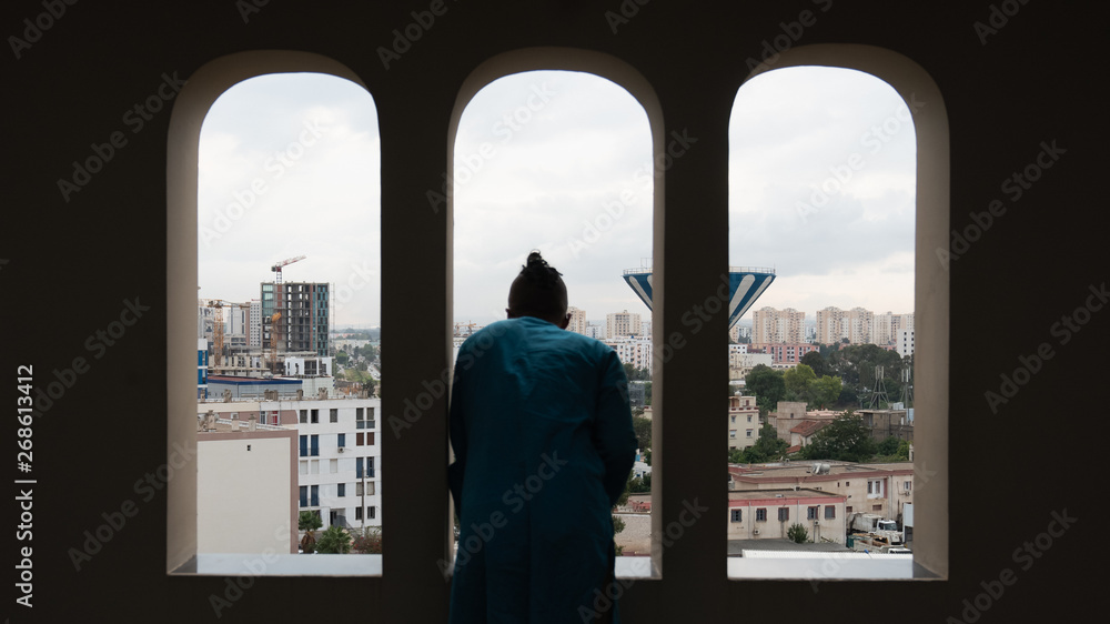 man looking through the window in Algiers man looking through the window in Algiers