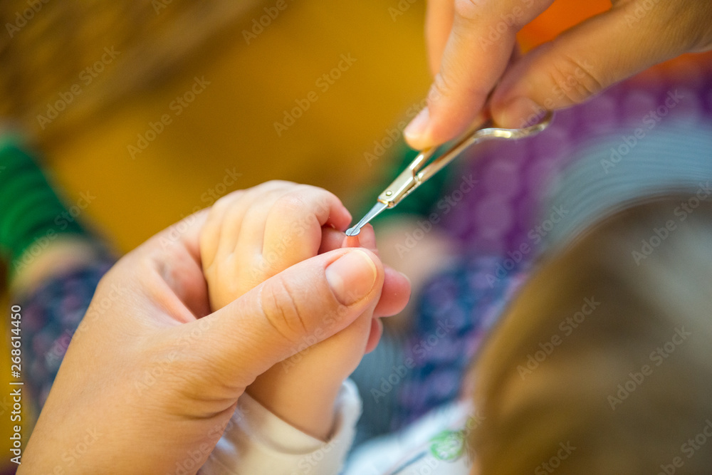 Mother is cutting nail. Mother is cutting nail.