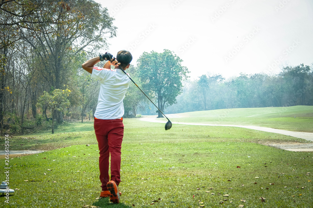 Fototapeta premium Blurred golfer playing golf in beautiful golf course in the evening golf course with sunshine in thailand