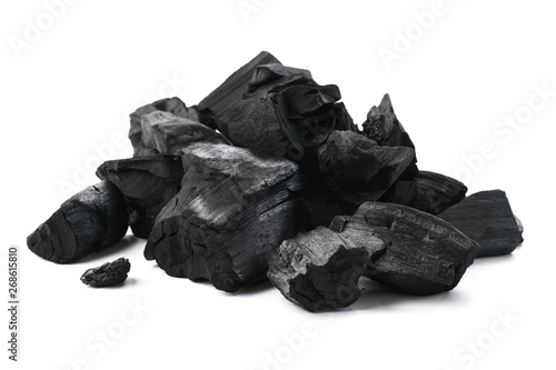 Pile of charcoal pieces isolated on white. photo