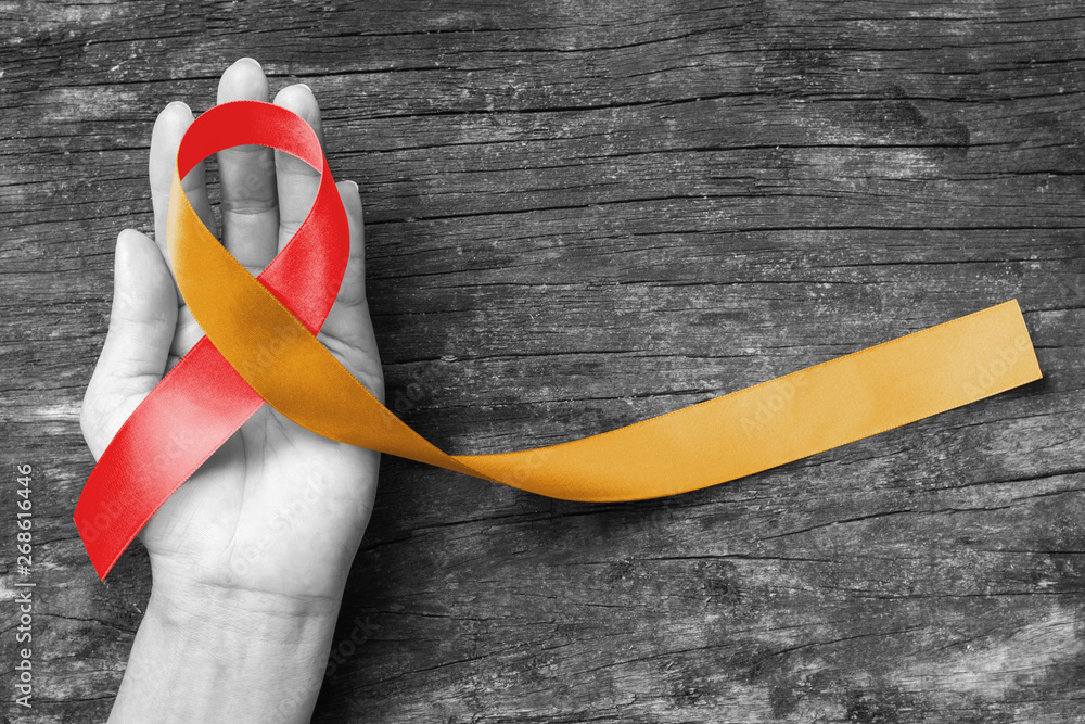 Red Gold ribbon awareness concept raising support or help people ...