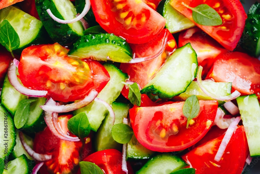 Fresh summer salad bowl with tomatoes, cucumbers, red onions, basil closeup. Fresh summer salad bowl with tomatoes, cucumbers, red onions, basil closeup.