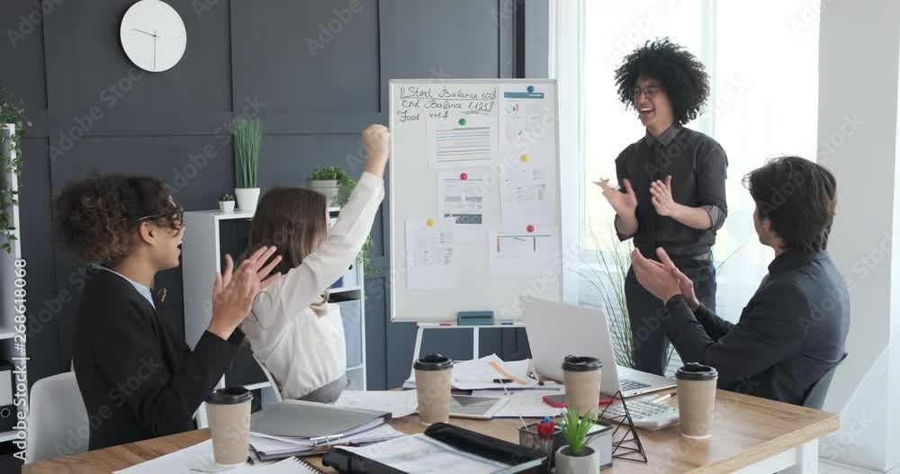 Happy business people clapping hands in a conference room Happy business people clapping hands in a conference room