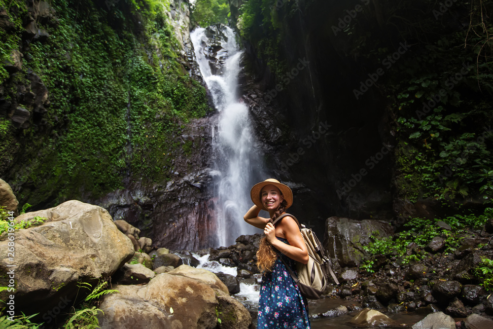 Woman near waterfal on Bali, Indonesia Woman near waterfal on Bali, Indonesia