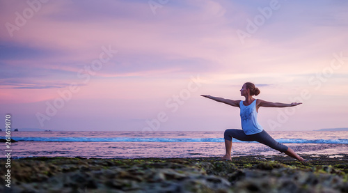 Fototapeta Naklejka Na Ścianę i Meble -  Caucasian woman practicing yoga at seashore