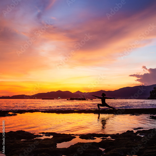 Caucasian woman practicing yoga at seashore © Maygutyak