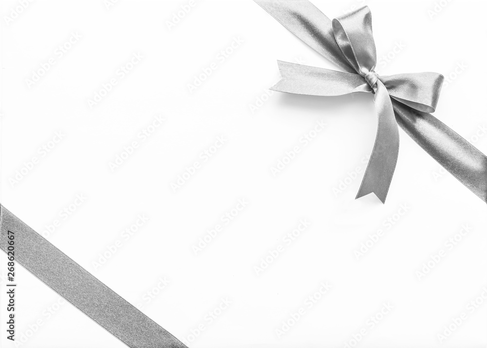 Silver pearl satin ribbon stripe corner fabric bow isolated on white background with clipping path Silver pearl satin ribbon stripe corner fabric bow isolated on white background with clipping path