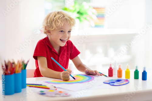 Kids paint. Child painting. Little boy drawing.