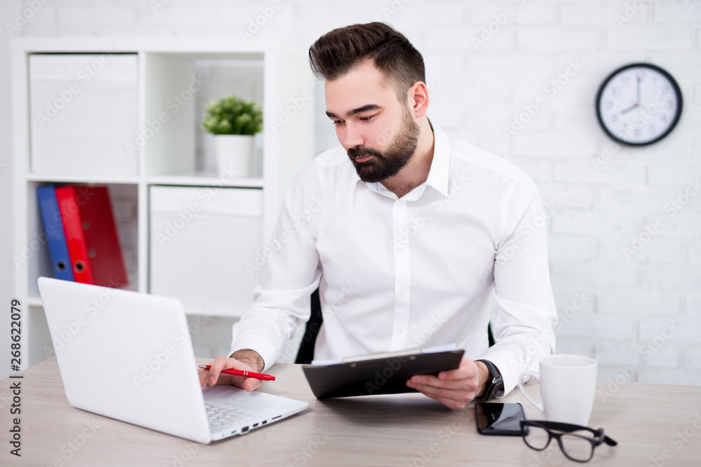 portrait of handsome bearded businessman working in office portrait of handsome bearded businessman working in office