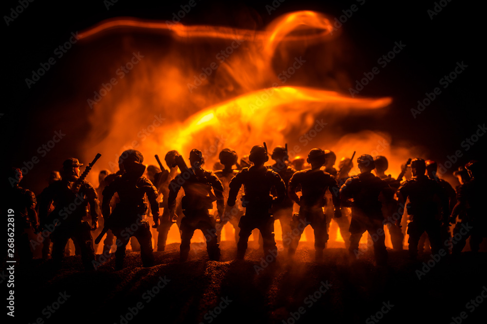 Fototapeta premium Anti-riot police give signal to be ready. Government power concept. Police in action. Smoke on a dark background with lights. Blue red flashing sirens.
