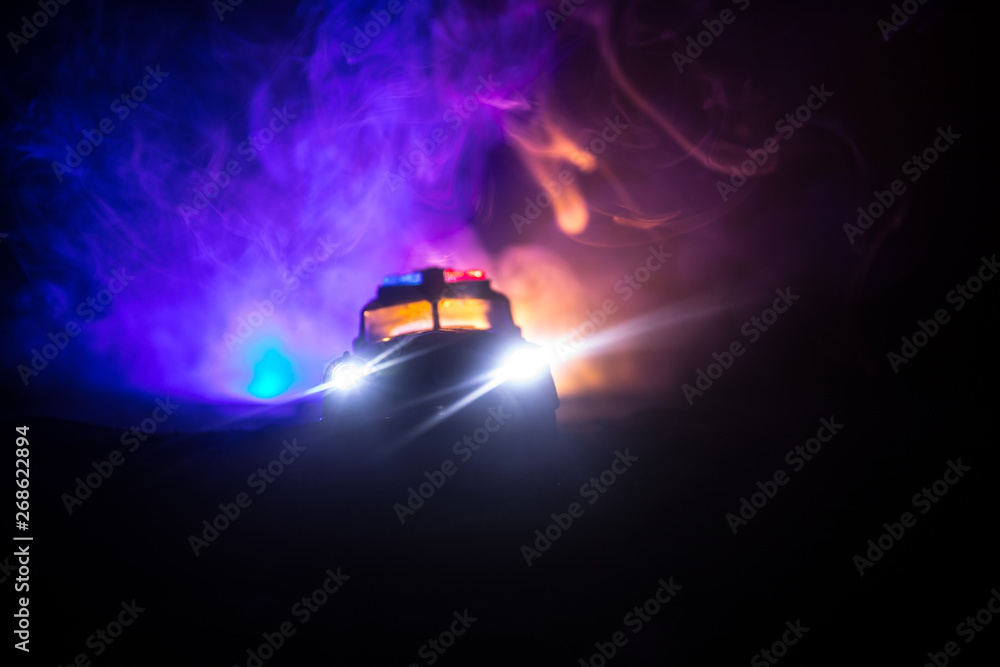 Police cars at night. Police car chasing a car at night with fog background. 911 Emergency response Police cars at night. Police car chasing a car at night with fog background. 911 Emergency response