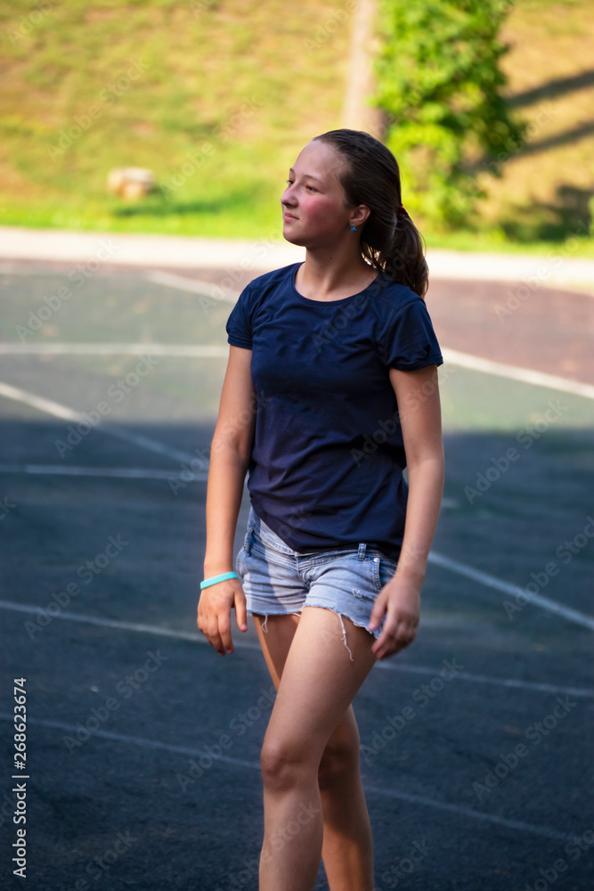 Portrait of teen girl on playground in summer park. Portrait of teen girl on playground in summer park.
