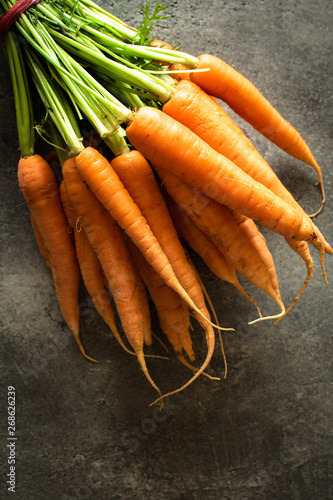 Nantes Carrots on Rustic Dark Background. Fresh Organic Superfood Healthy Eating Concept and Diabetes Control.