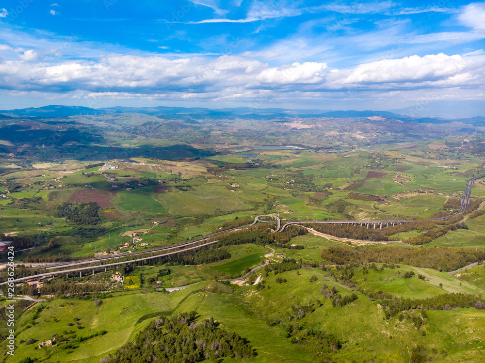 Expressway highway Sicily island Italy, near city of Enna. Blue sky with clouds