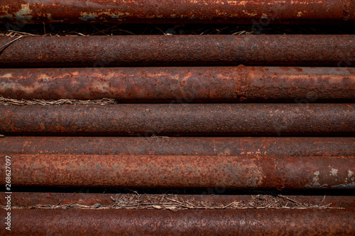 Rusty pipes. Corroded pipes lying parallel. Metal pipes.