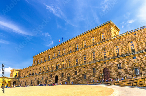 Facade of Palazzo Pitti palace with Gallery of Modern Art large building on Piazza dei Pitti square in historical centre of Florence city, blue sky white clouds, Tuscany, Italy photo