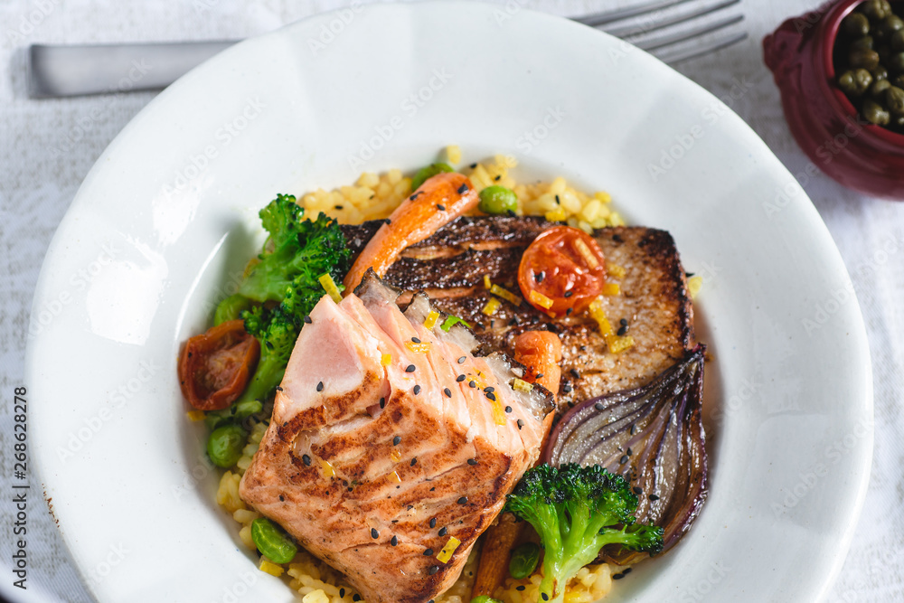 Roasted Salmon Fillet with Vegetables on Rustic White Plate. Healthy Food Concept.