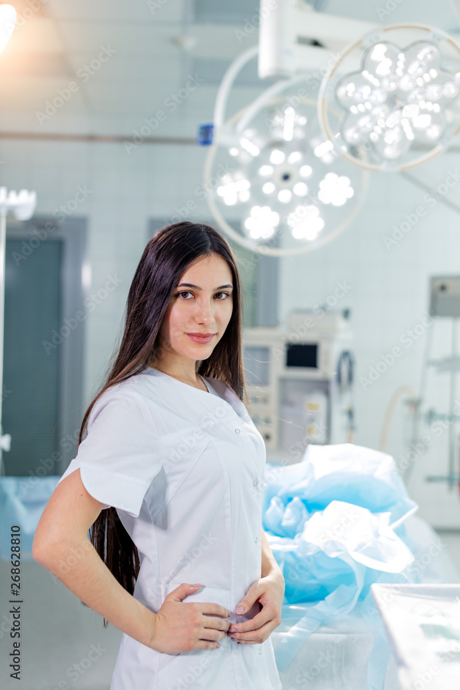 confident attractive woman in scrubs standing with hands on her hips and looking at the camera. close up photo.free time, lifestyle confident attractive woman in scrubs standing with hands on her hips and looking at the camera. close up photo.free time, lifestyle