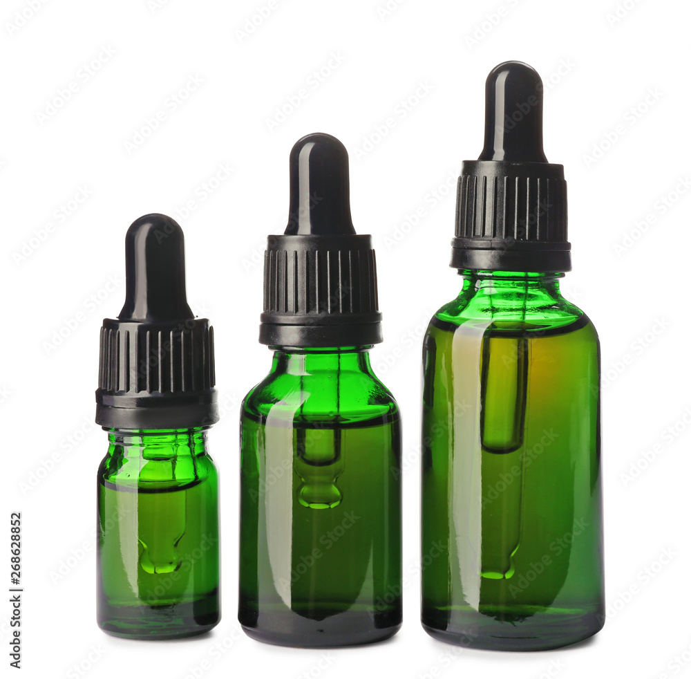 Cosmetic bottles of essential oils on white background Cosmetic bottles of essential oils on white background