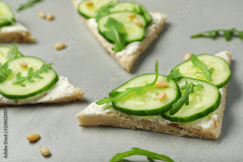 Traditional English cucumber sandwiches on grey table