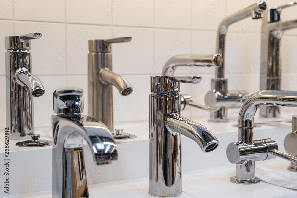 showcase in the store with faucets for the kitchen and bathroom