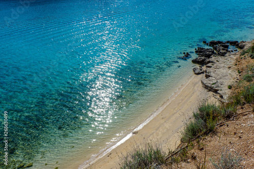 Fototapeta Naklejka Na Ścianę i Meble -  View from a beach during summer, located on a beautiful island of Rab on the Adriatic coast in the heart of Mediterranean sea. Surrounded by the crystal clear turquoise sea and blue sky.