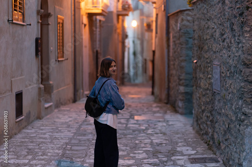 handsome tourist girl visiting narrow streets of old town in southern Italy, Basilicata Apulia region