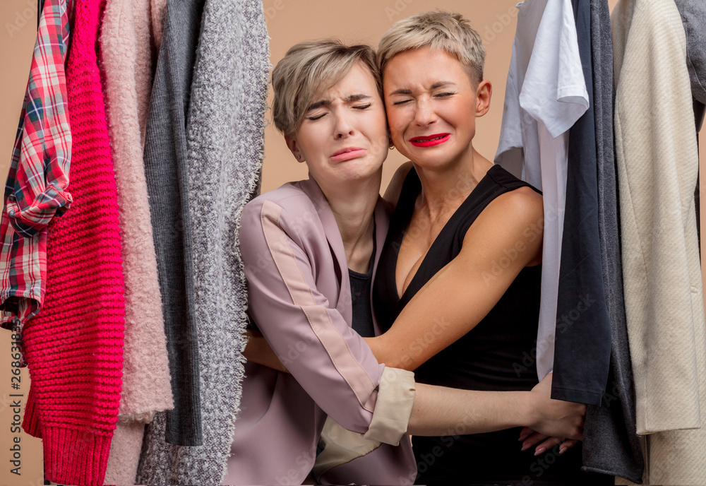 Obraz premium sad beautiful young women are crying while shopping. emotional prizes, sales.unhappy hugging girls have missed Black Friday